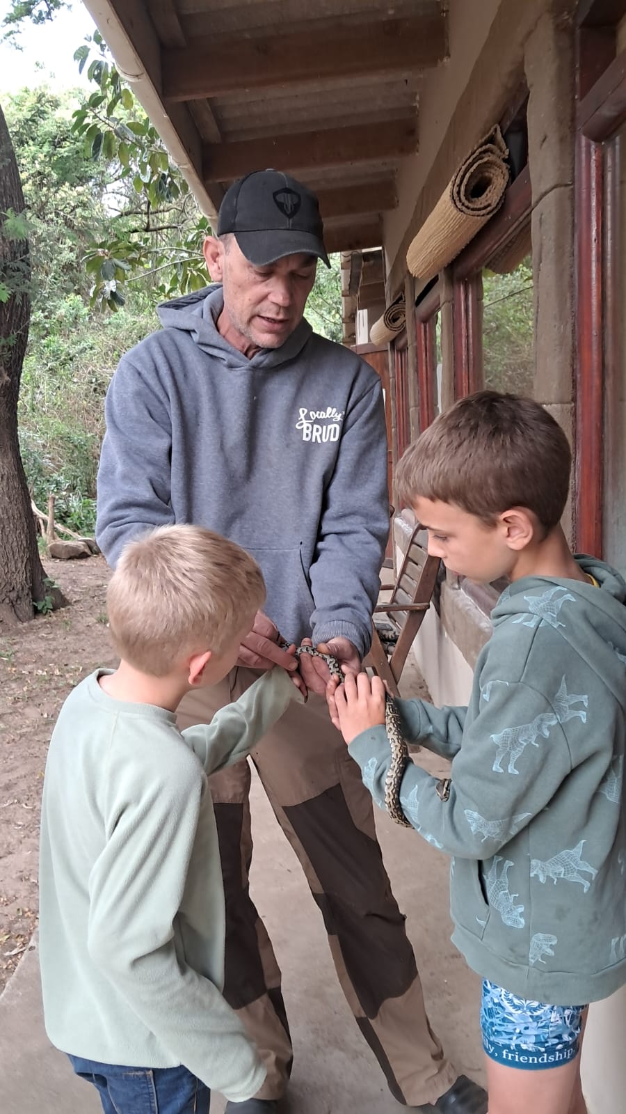 Donald demonstrating snake handling to a school group
